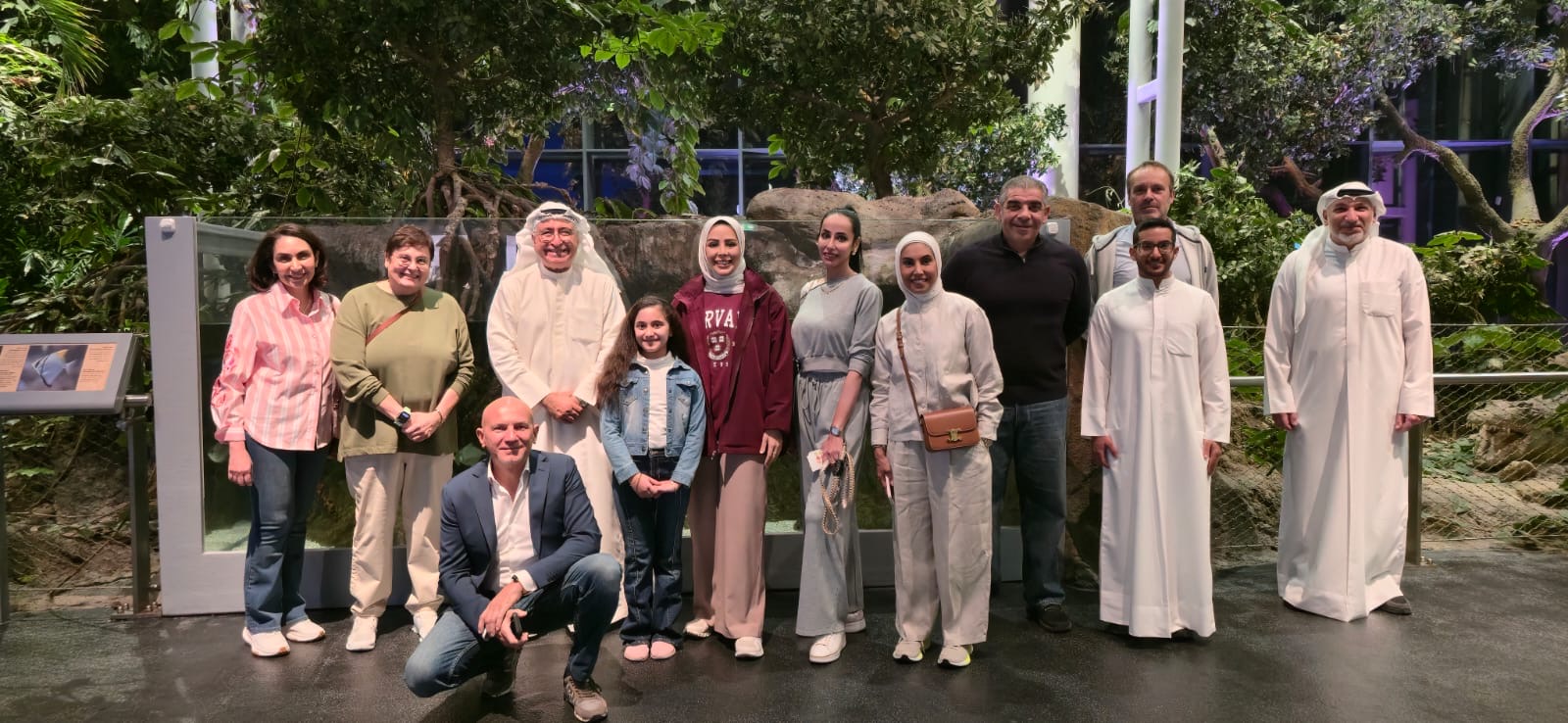 group posing in front of foliage
